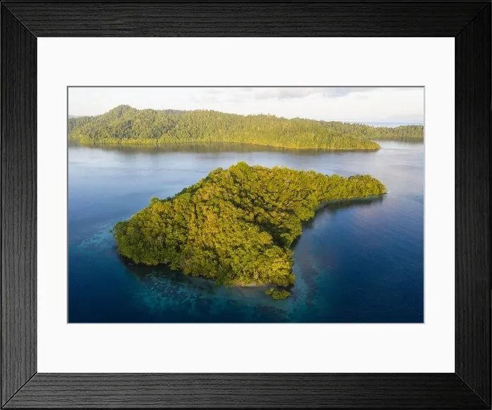 Framed Print : Seen from above, the many tropical islands within Raja Ampat, Indonesia, are surrounded by healthy coral reefs and high marine biodiversity Framed Print : Seen from above, the many tropical islands within Raja Ampat, Indonesia, are surrounded by healthy coral reefs and high marine biodiversity
