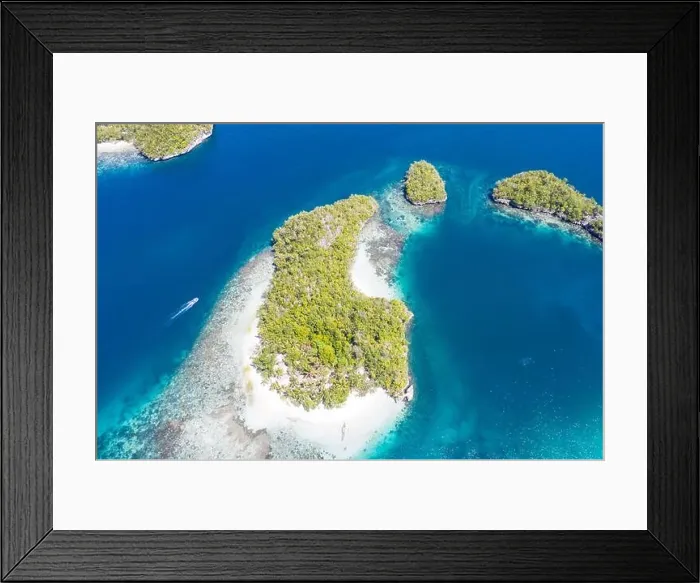 Framed Print : Seen from above, the many tropical islands within Raja Ampat, Indonesia, are surrounded by healthy coral reefs and high marine biodiversity Framed Print : Seen from above, the many tropical islands within Raja Ampat, Indonesia, are surrounded by healthy coral reefs and high marine biodiversity