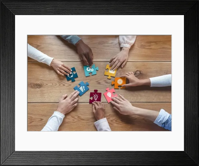 Framed Print : Hands of international coworkers putting colorful puzzles together Framed Print : Hands of international coworkers putting colorful puzzles together