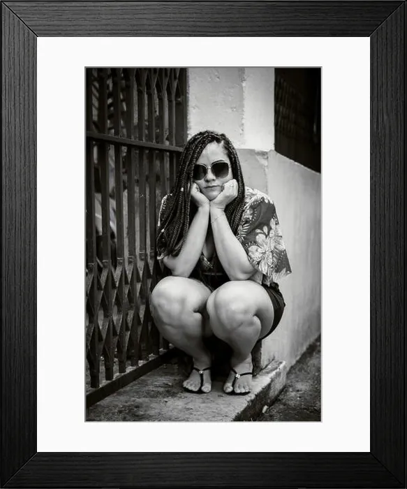 Framed Print : Black and white portrait of a woman wearing sunglasses crouching down looking at the camera with her hands on her chin. Pelourinho, Brazil Framed Print : Black and white portrait of a woman wearing sunglasses crouching down looking at the camera with her hands on her chin. Pelourinho, Brazil