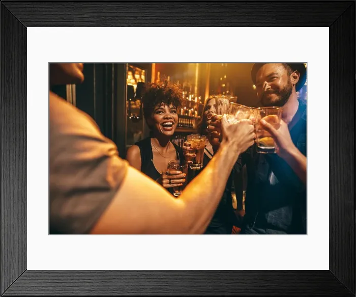 Framed Print : Group of young people toasting drinks at nightclub. Young men and women having fun at lounge bar Framed Print : Group of young people toasting drinks at nightclub. Young men and women having fun at lounge bar