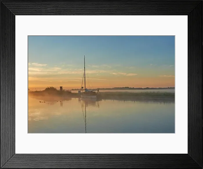 Framed Print : Potter Heigham, Norfolk Broads and a sailing boat moored on the River Thurne during a misty summer sunrise Framed Print : Potter Heigham, Norfolk Broads and a sailing boat moored on the River Thurne during a misty summer sunrise