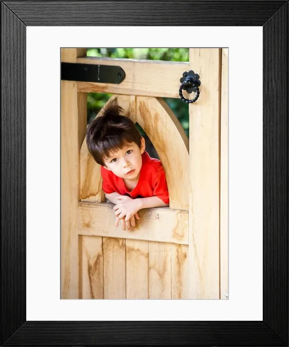 Framed Print : Caucasian child, boy, 5-6 year old, leaning against the other side of wooden gate with his head sticking through the wooden arch Framed Print : Caucasian child, boy, 5-6 year old, leaning against the other side of wooden gate with his head sticking through the wooden arch