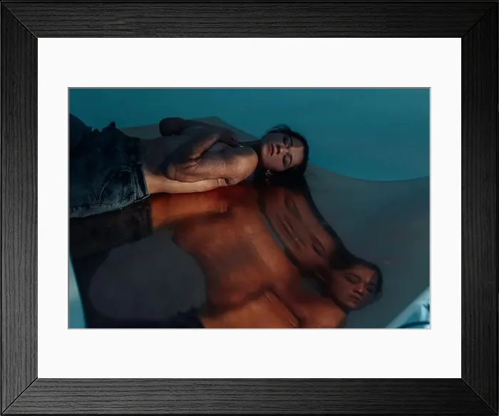 Framed Print : Beautiful young woman with amputee arm and scars from burn on her body poses lying topless. There is visible her reflection on surface. The concept of Framed Print : Beautiful young woman with amputee arm and scars from burn on her body poses lying topless. There is visible her reflection on surface. The concept of