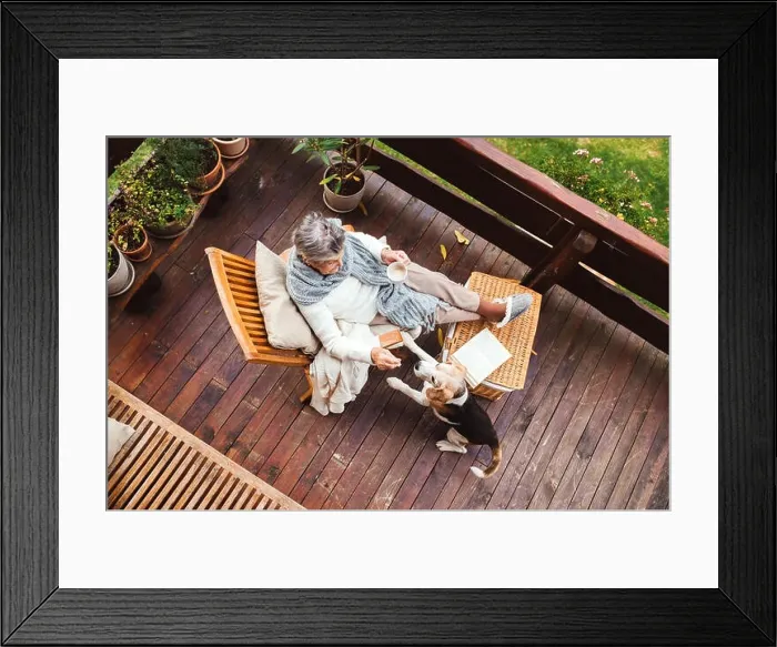 Framed Print : An elderly woman with a dog sitting outdoors on a terrace on a sunny day in autumn Framed Print : An elderly woman with a dog sitting outdoors on a terrace on a sunny day in autumn
