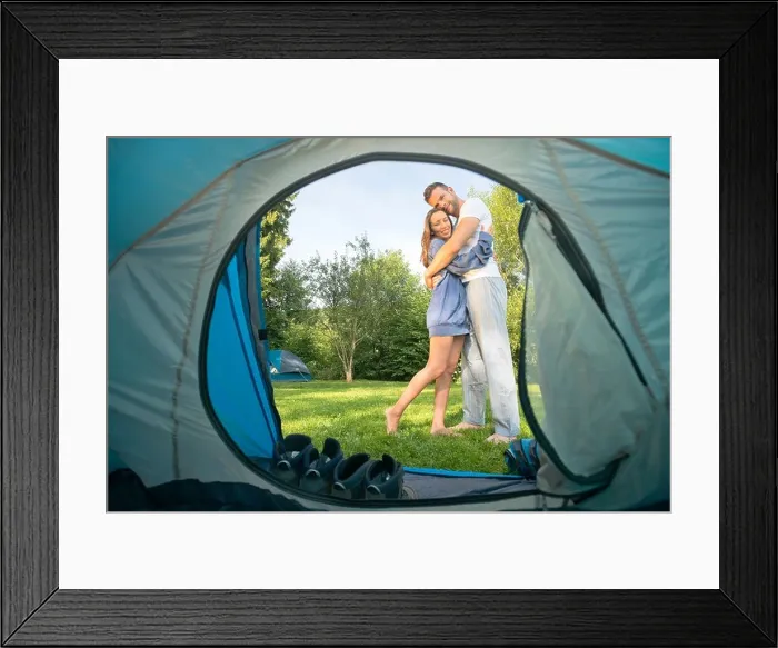 Framed Print : Portrait of a young couple hugging in front of a tent