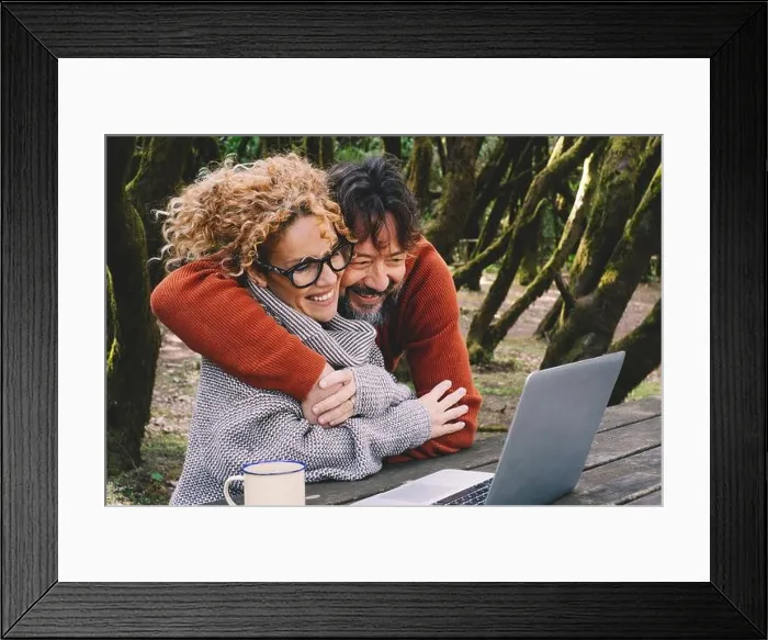Framed Print : Happy couple in love and friendship enjoy video call on laptop together hugging and smiling. Nature outdoors forest background Framed Print : Happy couple in love and friendship enjoy video call on laptop together hugging and smiling. Nature outdoors forest background