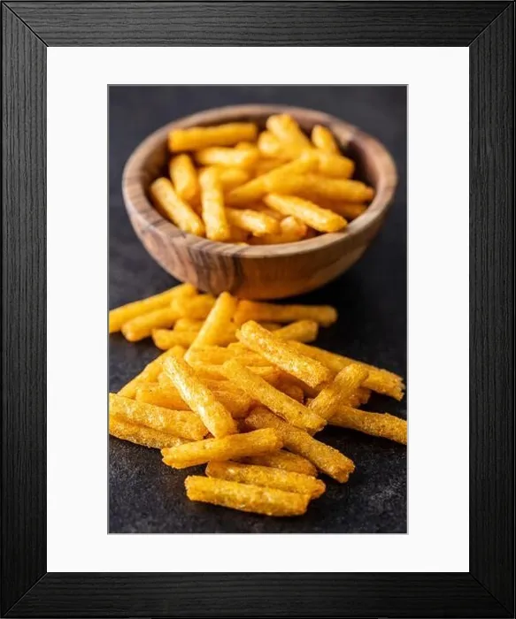 Framed Print : French fries. Salted snack. Potato chips on black table Framed Print : French fries. Salted snack. Potato chips on black table