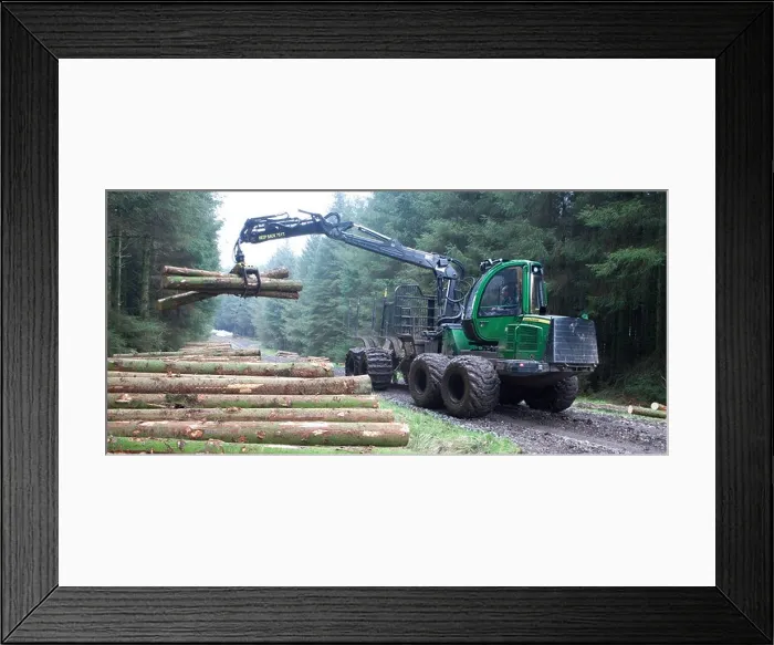 Framed Print : Commercial forestry a forwarder, all terrain vehicle, working picking up cut trees lumber in the forest Forestry Commission, UK Framed Print : Commercial forestry a forwarder, all terrain vehicle, working picking up cut trees lumber in the forest Forestry Commission, UK