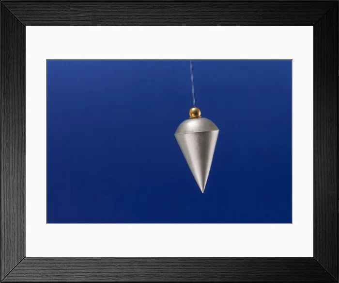 Framed Print : A silver pendulum swinging from side to side Framed Print : A silver pendulum swinging from side to side
