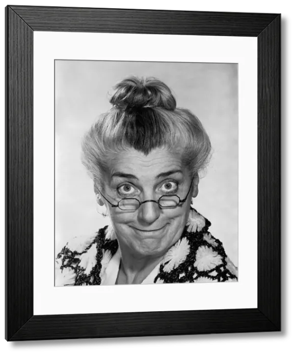 Framed Print : 1970s PORTRAIT ELDERLY WOMAN WITH HAIR IN BUN WEARING GRANNY GLASSES SMILING LOOKING AT CAMERA Framed Print : 1970s PORTRAIT ELDERLY WOMAN WITH HAIR IN BUN WEARING GRANNY GLASSES SMILING LOOKING AT CAMERA