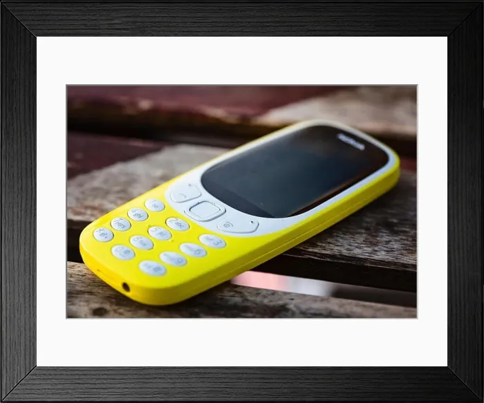 Framed Print : Prague, Czech Republic, September 14, 2019: Mobile Phone Nokia 3310 Yellow on table Framed Print : Prague, Czech Republic, September 14, 2019: Mobile Phone Nokia 3310 Yellow on table