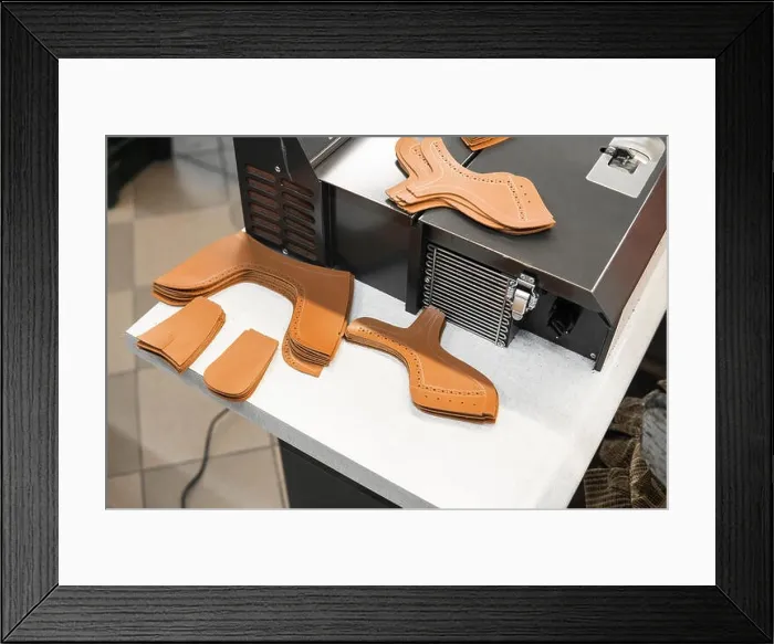 Framed Print : Different forms of leather pieces which will be use for making a shoes on a shoes factory. Prepared, bundled leather parts, used in the production of Framed Print : Different forms of leather pieces which will be use for making a shoes on a shoes factory. Prepared, bundled leather parts, used in the production of