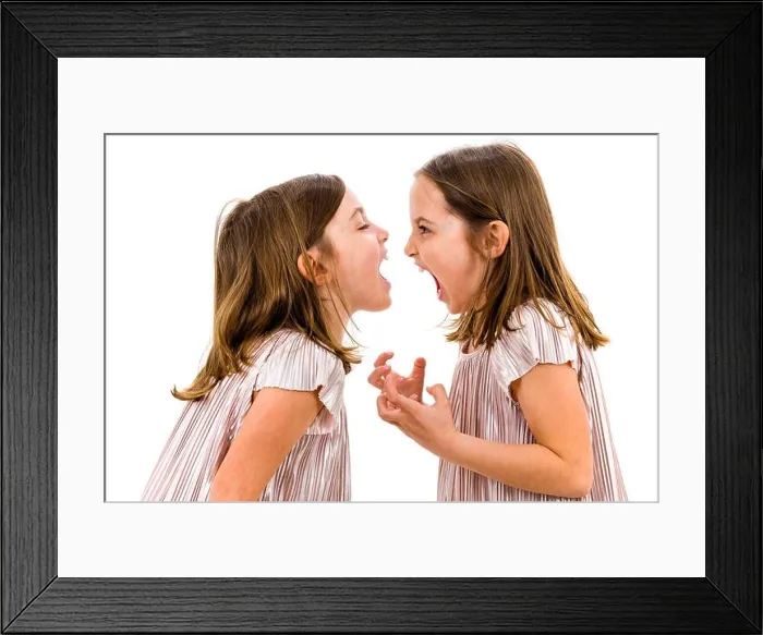 Framed Print : Identical twin girls sisters are arguing yelling at each other. Angry girls are shouting, yelling and arguing with emotional expression on faces. Fron Framed Print : Identical twin girls sisters are arguing yelling at each other. Angry girls are shouting, yelling and arguing with emotional expression on faces. Fron