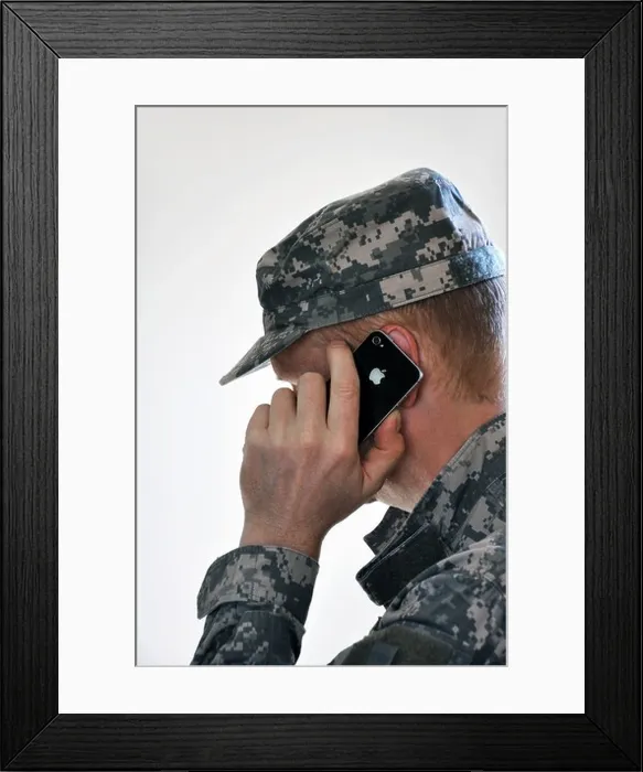 Framed Print : Soldier with iPhone making phone call Framed Print : Soldier with iPhone making phone call
