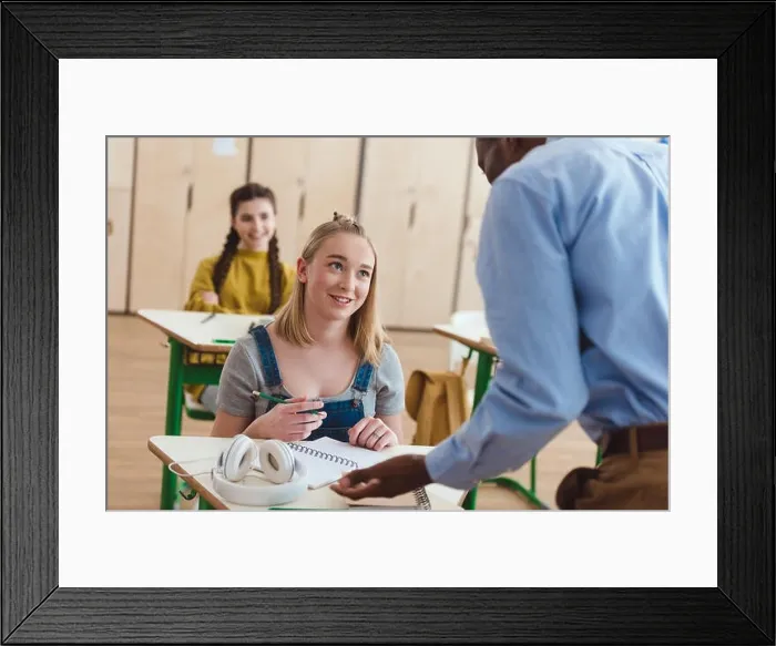 Framed Print : Rear view of african american teacher talking to high school teenage student Framed Print : Rear view of african american teacher talking to high school teenage student