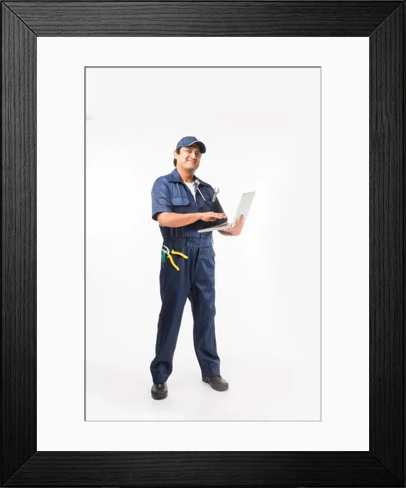 Framed Print : Indian happy auto mechanic in blue suit and cap holding spanner tool in action, isolated over white background Framed Print : Indian happy auto mechanic in blue suit and cap holding spanner tool in action, isolated over white background