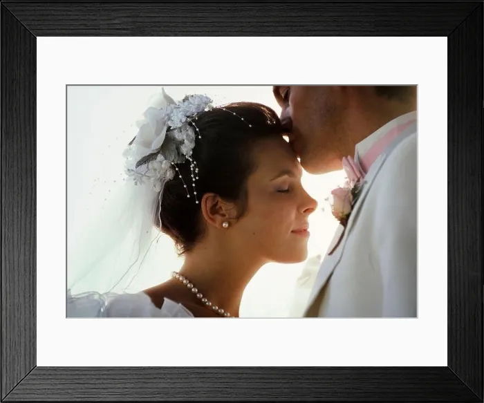 Framed Print : Just married, new Caucasian husband kisses his beautiful young wife on the forehead Framed Print : Just married, new Caucasian husband kisses his beautiful young wife on the forehead