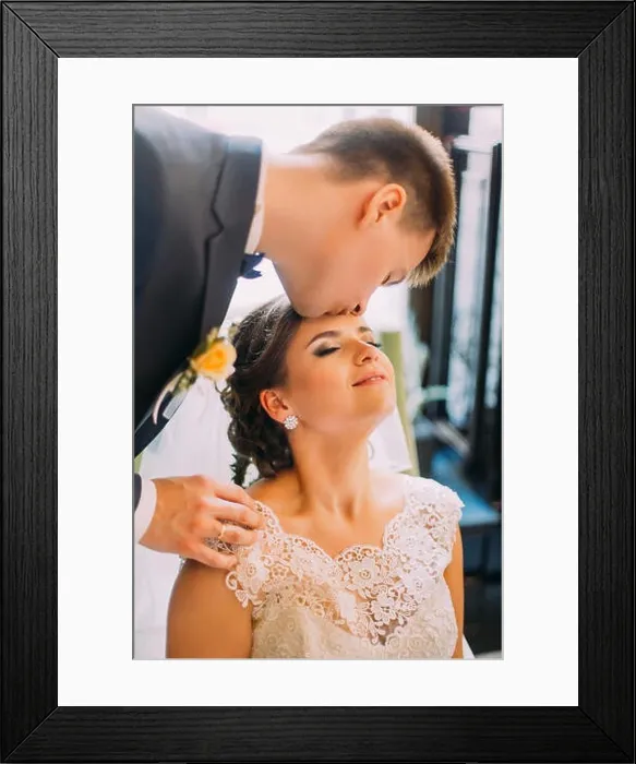Framed Print : Handsome young groom kissing his beautiful bride before honeymoon Framed Print : Handsome young groom kissing his beautiful bride before honeymoon