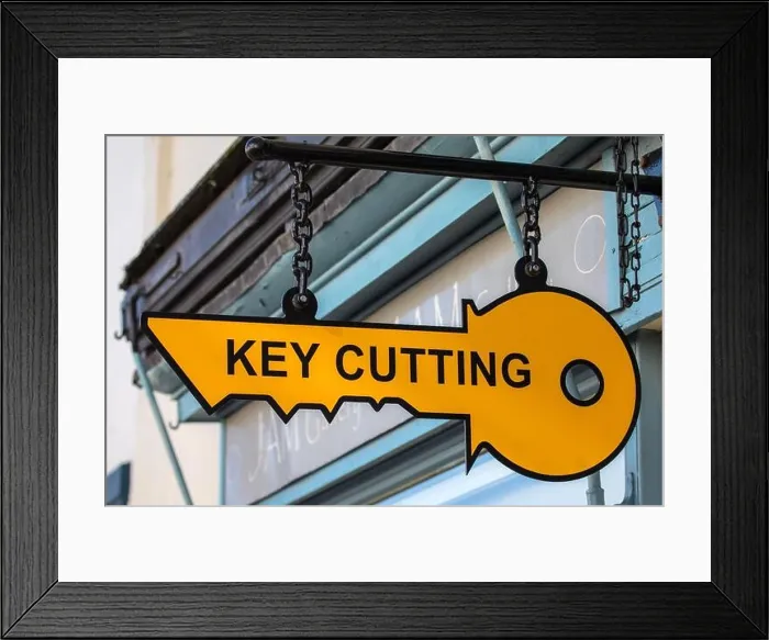 Framed Print : Close-up of a Key Cutting sign above the entrance to a shop Framed Print : Close-up of a Key Cutting sign above the entrance to a shop