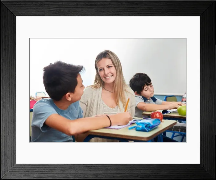 Framed Print : Full time teacher or elementary school teacher tutoring a student Framed Print : Full time teacher or elementary school teacher tutoring a student