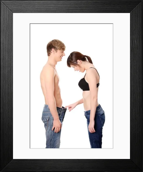 Framed Print : Girl looking in mens pants. Isolated on white background Framed Print : Girl looking in mens pants. Isolated on white background