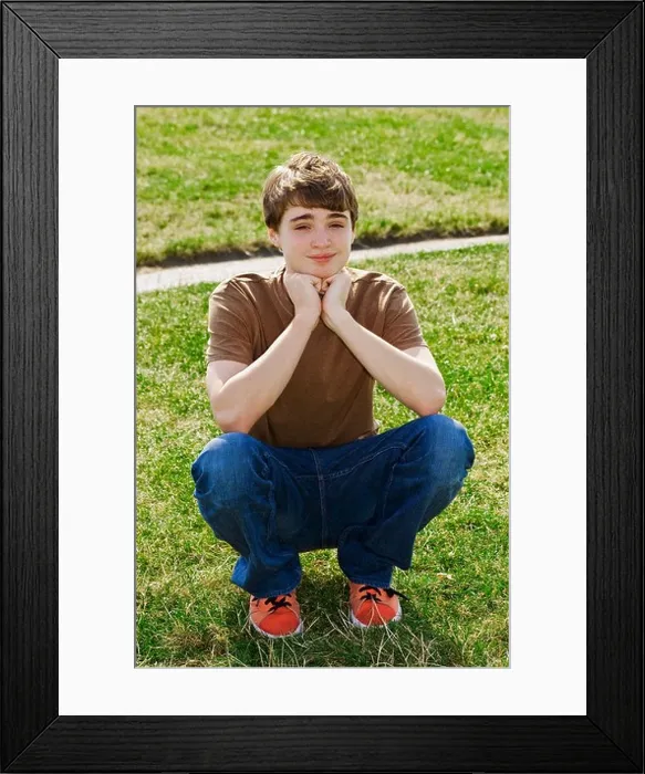 Framed Print : young teen boy sitting in park 12-14 years old Framed Print : young teen boy sitting in park 12-14 years old