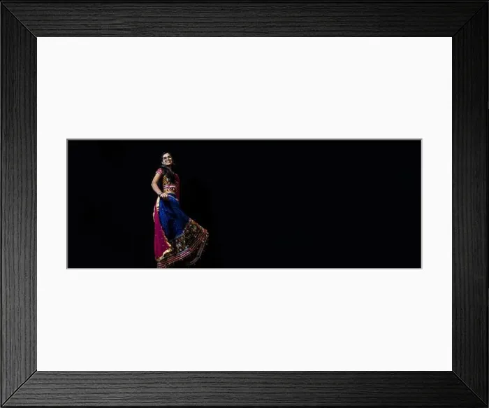 Framed Print : Indian girl in traditional chaniya choli for navratri with a fashionable hairstyle poses in studio on black background. Navratri is an Indian Festival Framed Print : Indian girl in traditional chaniya choli for navratri with a fashionable hairstyle poses in studio on black background. Navratri is an Indian Festival