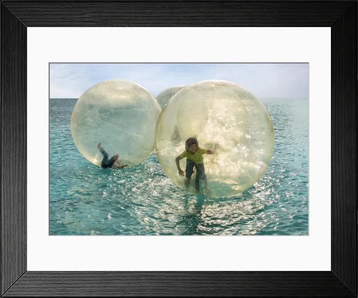 Framed Print : Children have fun inside plastic balloons on the water Framed Print : Children have fun inside plastic balloons on the water