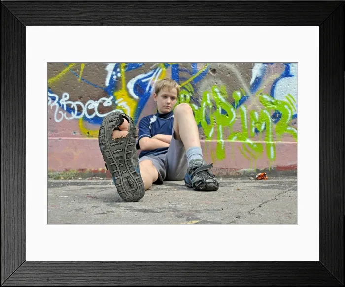 Framed Print : 9-year-old boy, bored, football ground in Cologne, North Rhine-Westphalia, Germany, Europe