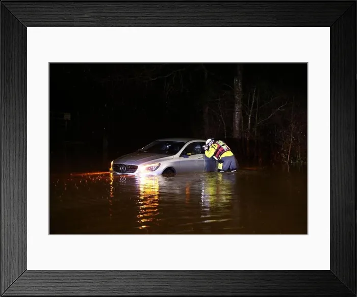 Framed Print : Hathern, Leicestershire, UK. 2nd January 2024. UK weather. A Fire Fighter checks inside a car stranded in flood water Framed Print : Hathern, Leicestershire, UK. 2nd January 2024. UK weather. A Fire Fighter checks inside a car stranded in flood water