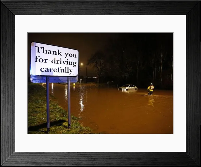Framed Print : Hathern, Leicestershire, UK. 2nd January 2024. UK weather. A Fire Fighter checks inside a car stranded in flood water Framed Print : Hathern, Leicestershire, UK. 2nd January 2024. UK weather. A Fire Fighter checks inside a car stranded in flood water