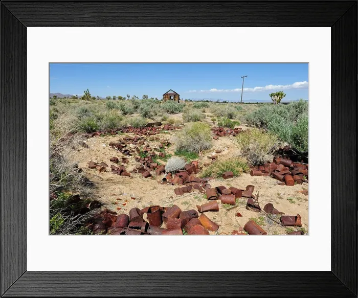 Framed Print : Rusting tin cans in the Mojave National Preserve with wooden dwelling in the distant back ground, located in Cima Framed Print : Rusting tin cans in the Mojave National Preserve with wooden dwelling in the distant back ground, located in Cima