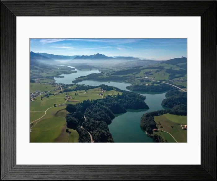 Framed Print : Aerial view of the Lac de la Gruyere, a lake in the canton of Fribourg, Switzerland. The lake winds through the hills of the region Framed Print : Aerial view of the Lac de la Gruyere, a lake in the canton of Fribourg, Switzerland. The lake winds through the hills of the region