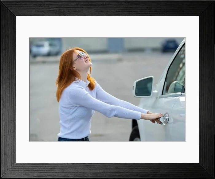Framed Print : A woman trying to open closed car doors Framed Print : A woman trying to open closed car doors