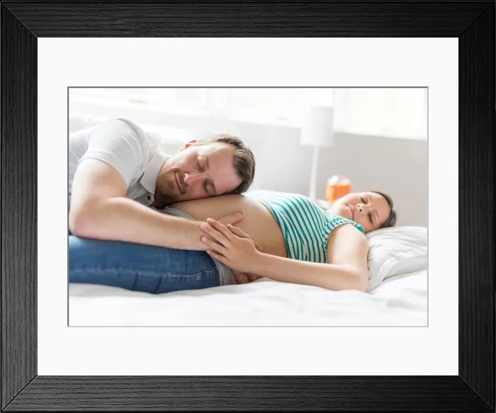 Framed Print : Young parents in bed expecting a little baby, Romantic moments for pregnant couple Framed Print : Young parents in bed expecting a little baby, Romantic moments for pregnant couple