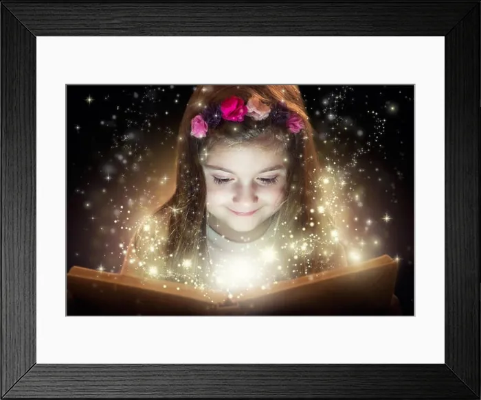 Framed Print : Little girl reading magic book, fantasy concept Framed Print : Little girl reading magic book, fantasy concept