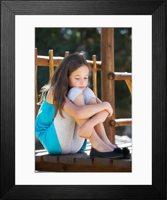 Framed Print : Sad Young Girl Sitting On Climbing Frame Framed Print : Sad Young Girl Sitting On Climbing Frame