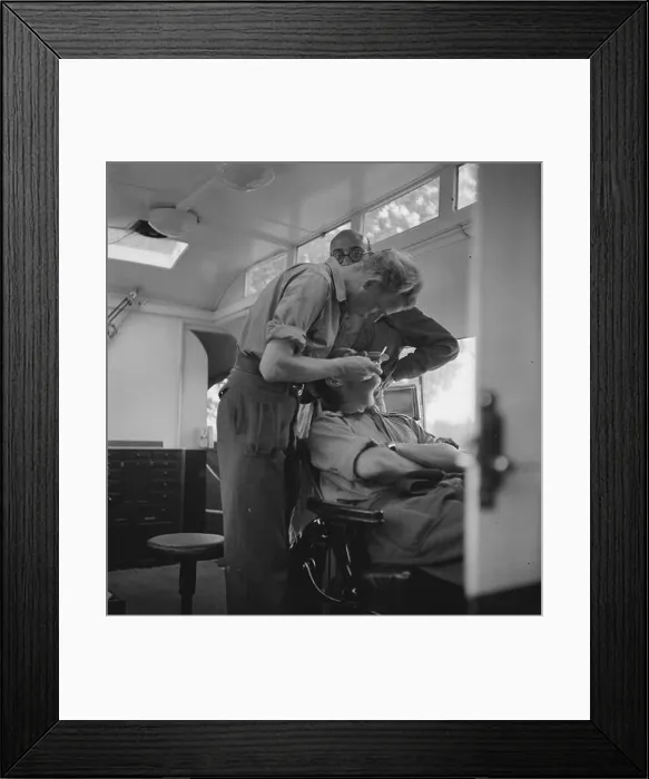 Framed Print : Royal Dutch Brigade Princess Irene. Landing in Normandy. The dentist with his first patient Date: August 1944 Location: France Framed Print : Royal Dutch Brigade Princess Irene. Landing in Normandy. The dentist with his first patient Date: August 1944 Location: France