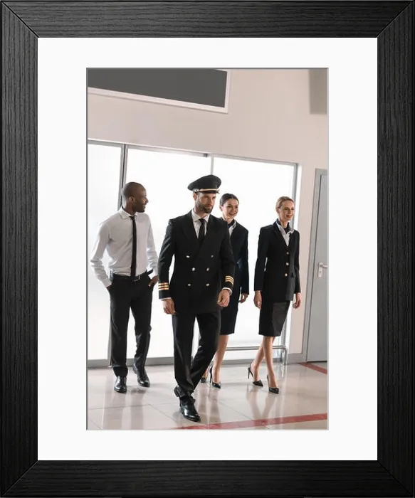 Framed Print : happy aviation personnel team in professional uniform walking by airport Framed Print : happy aviation personnel team in professional uniform walking by airport
