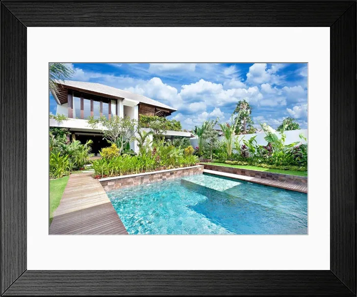 Framed Print : Modern blue water swimming pool in a luxury house with a fancy garden around it