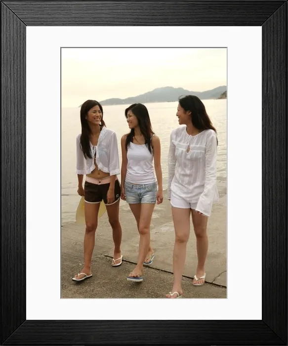 Framed Print : Three young women walking on a pier Framed Print : Three young women walking on a pier