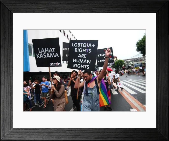 Framed Print : A participant holding a poster during the Pride March. Thousands of gay members marched through the streets of Marikina Framed Print : A participant holding a poster during the Pride March. Thousands of gay members marched through the streets of Marikina