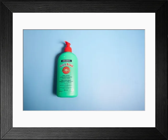 Framed Print : Halifax, Canada - April 11, 2020: A green bottle of Gold Bond brand medicated hand lotion Framed Print : Halifax, Canada - April 11, 2020: A green bottle of Gold Bond brand medicated hand lotion