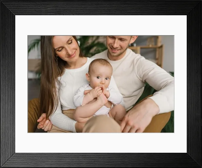 Framed Print : Mom, dad and six-month-old baby son in their arms spend time together in their cozy home Framed Print : Mom, dad and six-month-old baby son in their arms spend time together in their cozy home