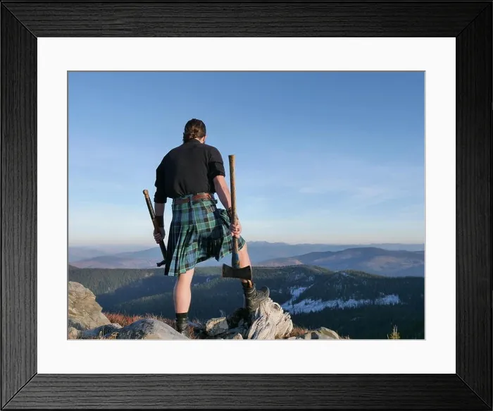 Framed Print : man in Scottish kilt on mountain top with old axes in hand Framed Print : man in Scottish kilt on mountain top with old axes in hand