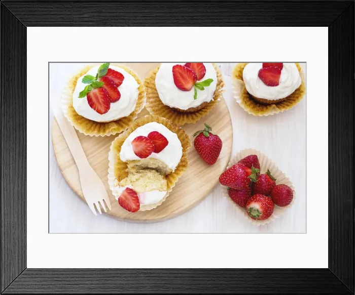 Framed Print : Homemade strawberry cupcakes with whipped cream topping, top view Framed Print : Homemade strawberry cupcakes with whipped cream topping, top view