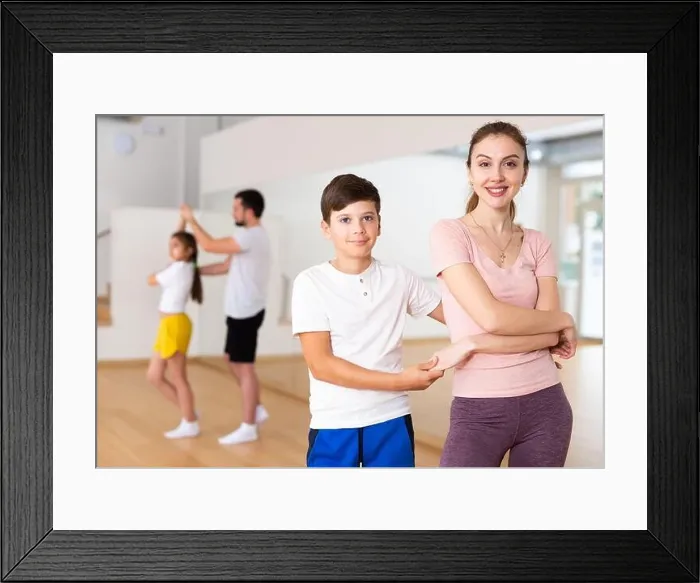 Framed Print : Mother dancing with her son during group family training