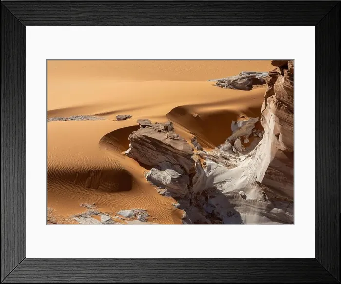 Framed Print : A crumbling white rock formation in the curvy orange sands of the Sahara desert near Ounianga Kébir