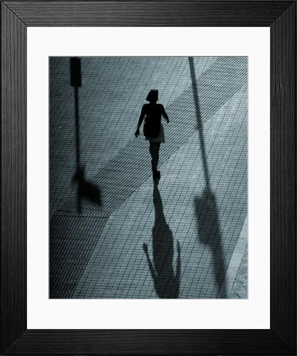 Framed Print : Silhouette of a woman walking in a street at night Framed Print : Silhouette of a woman walking in a street at night